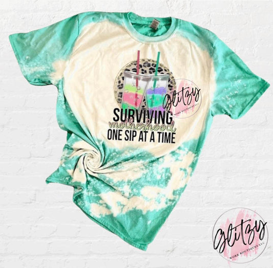 Surviving Motherhood One Sip at a Time Bleached Tee